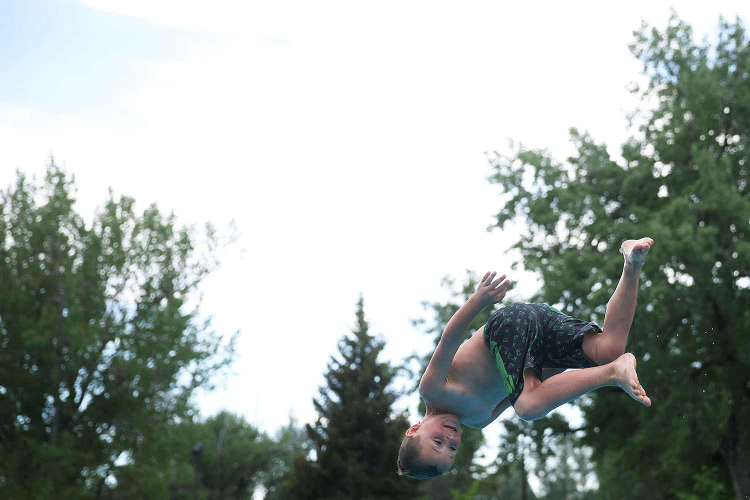 Wesson Thums, 6, flips forward off of the diving board